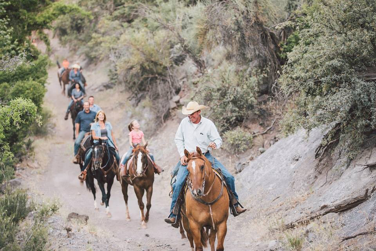 Trail guide with riders following.